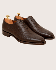 Leather sole and hand welted stitching on a men's ostrich wholecut oxford