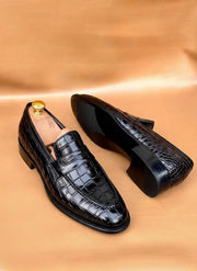 Black crocodile embossed penny loafers for men with a twisted strap