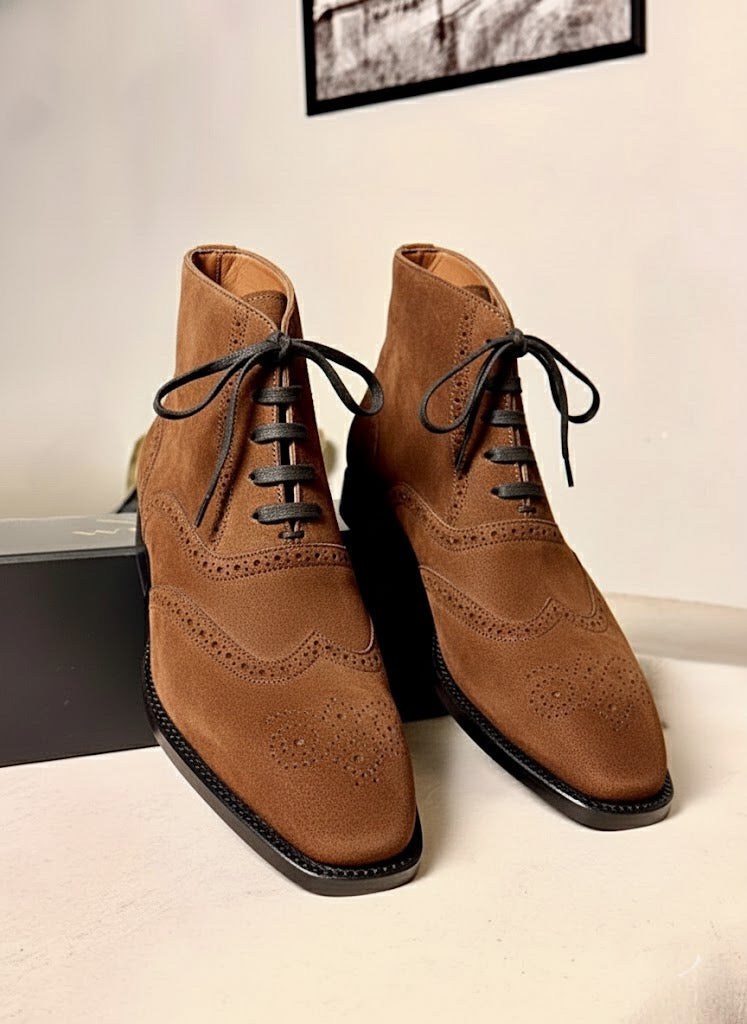 Saddle brown wingtip suede boots