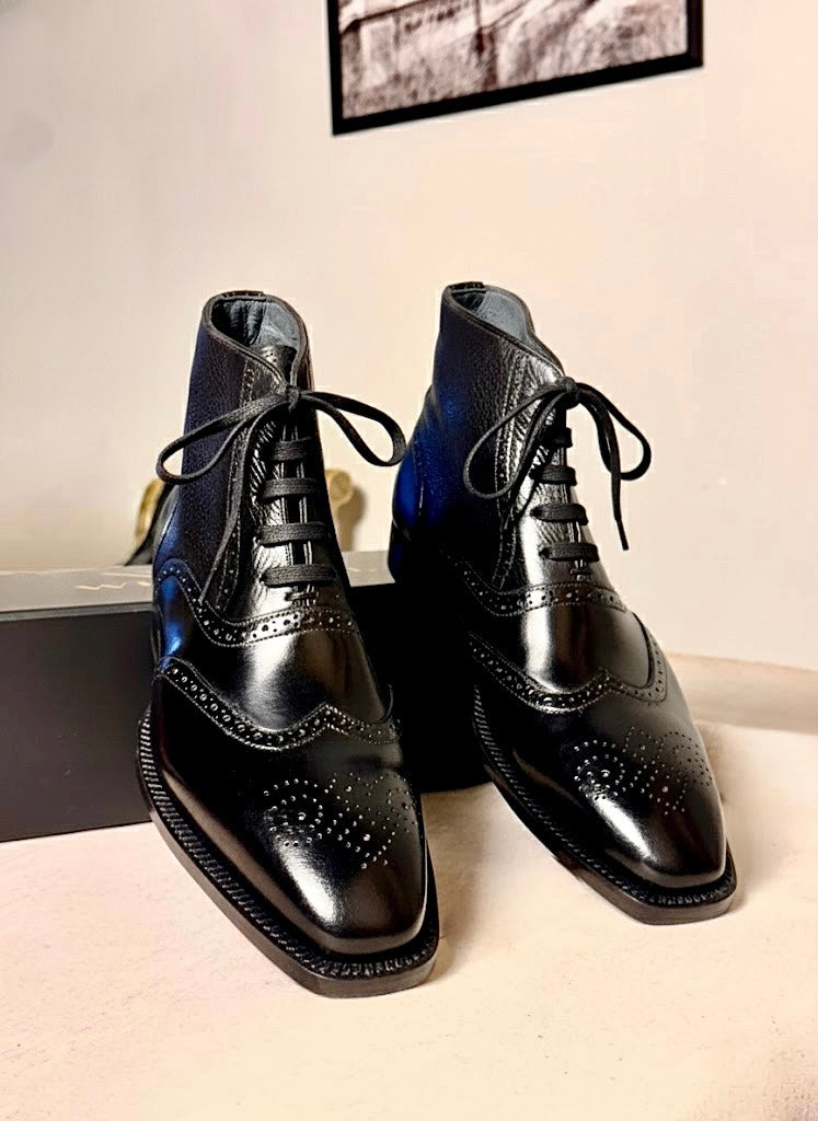 Black wingtip boots