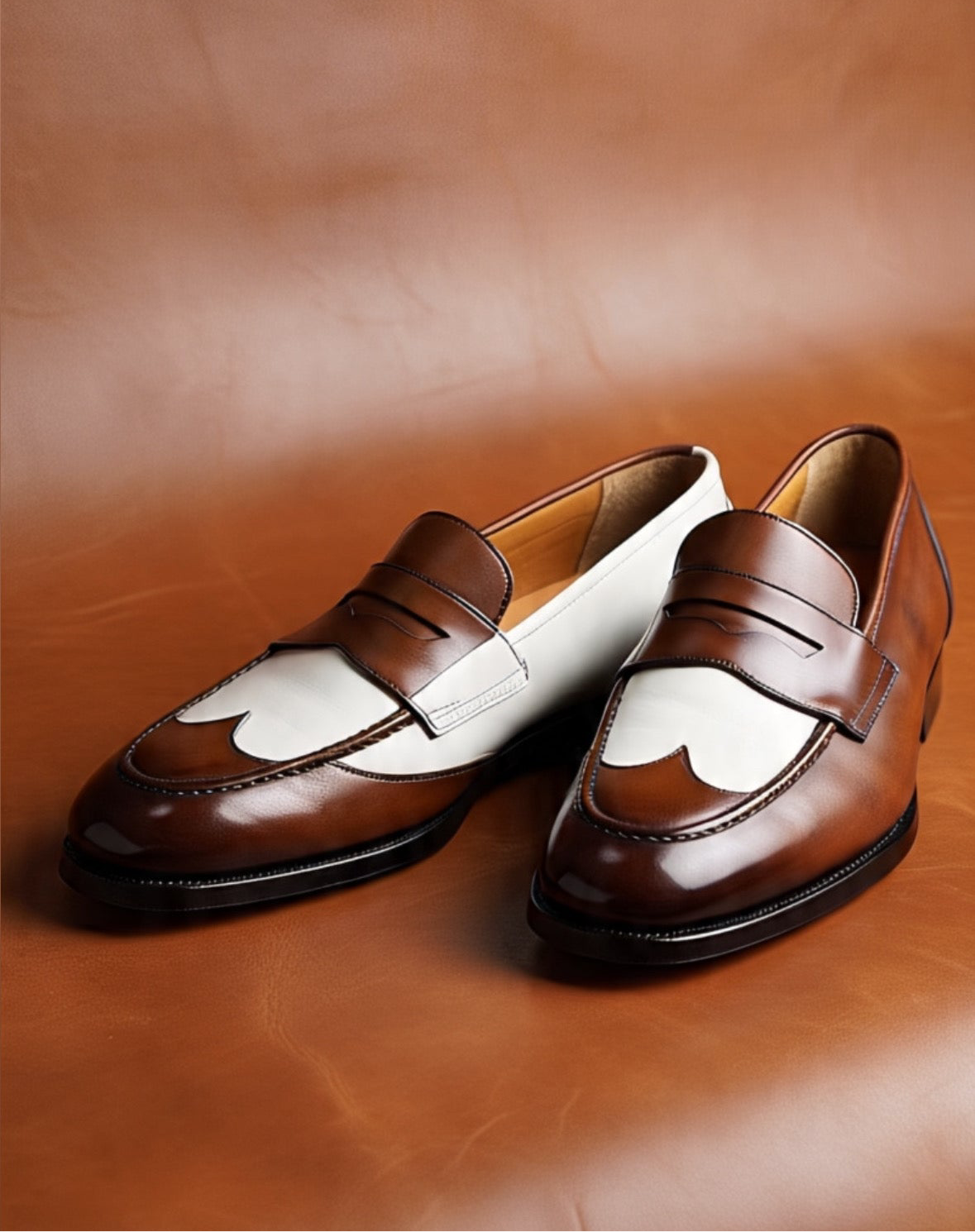 Men's brown and white spectator penny loafers, three-quarter view