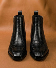black crocodile boots styled with dark denim

