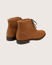 Saddle brown wingtip suede boots