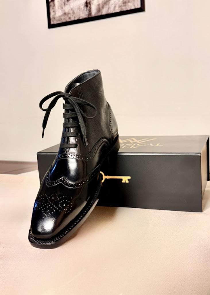 Black wingtip boots