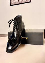 Black wingtip boots