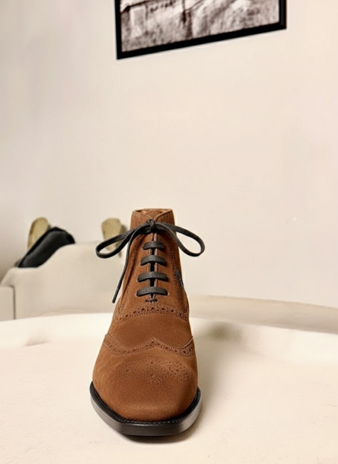 Saddle brown wingtip suede boots