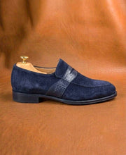 Men's blue suede penny loafers, three-quarter view