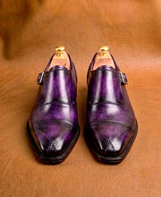 Buckle and strap closure on a purple monk strap