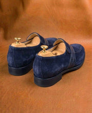 Men's blue suede penny loafers, three-quarter view