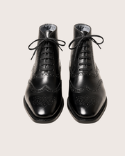 Black wingtip boots