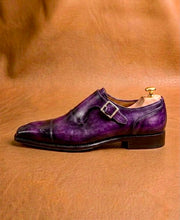Leather sole and stacked heel of a purple patina monk strap