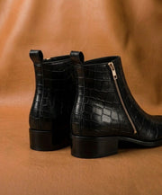 genuine crocodile leather scales close up black boot
