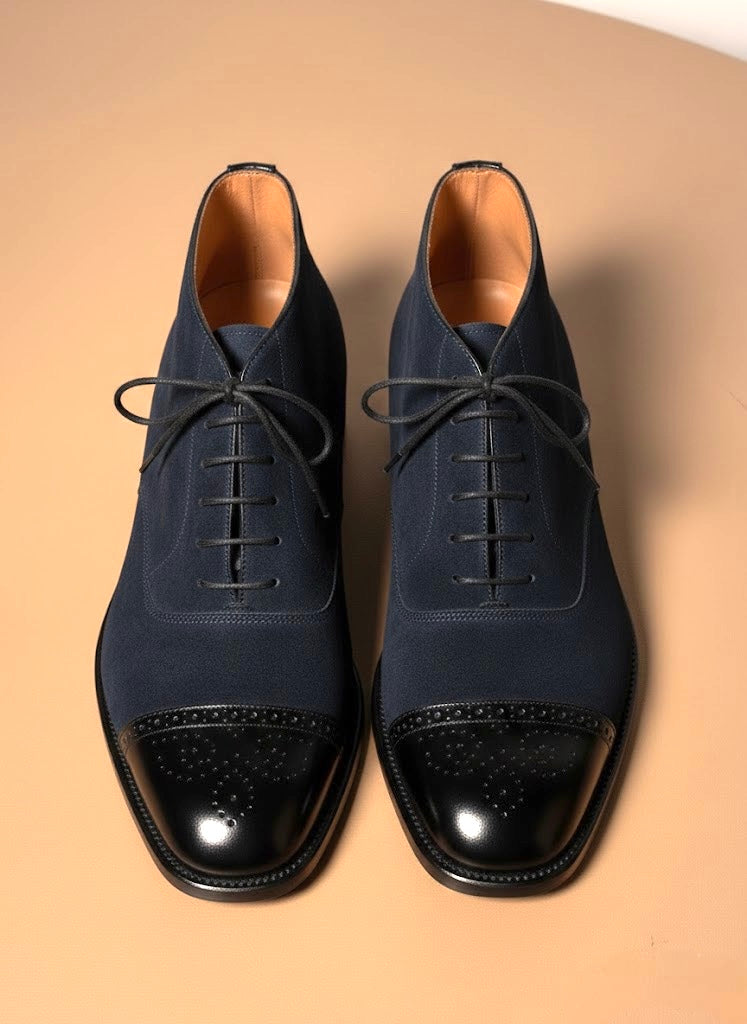 Men's navy blue suede chukka boots, three quarter view